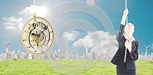 Composite image of businesswoman pulling a chain