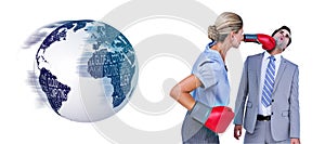 Composite image of businesswoman punching colleague with boxing gloves