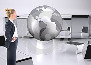 Composite image of businesswoman standing with hands on hips