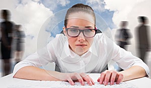 Composite image of businesswoman typing on a keyboard