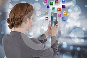 Composite image of businesswoman using mobile phone 3d