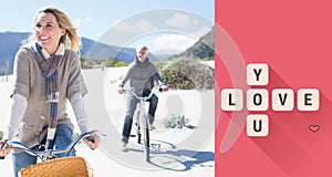 Composite image of carefree couple going on a bike ride on the beach