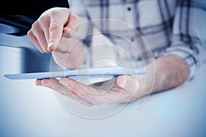 Composite image of casual man using tablet pc