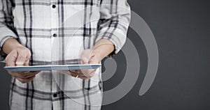 Composite image of casual man using tablet pc