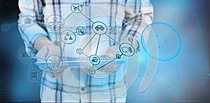 Composite image of casual man using tablet pc