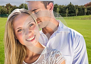 Composite image of caucasian couple embracing each other against golf course with copy space