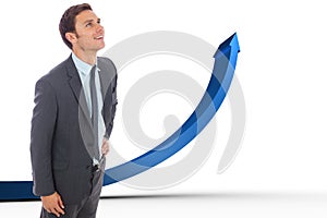 Composite image of cheerful businessman standing with hand on hip