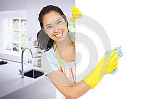 Composite image of cheerful woman cleaning white surface