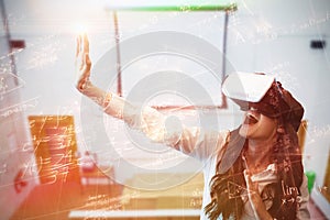 Composite image of cheerful woman gesturing while wearing virtual reality glasses