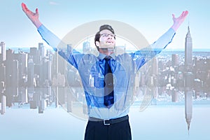 Composite image of cheering businessman with his arms raised up