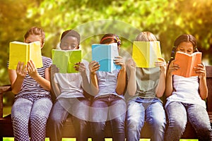 Composite image of children reading books at park