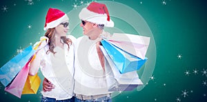 Composite image of christmas couple with shopping bags