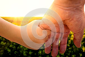 Composite image of close up of father holding his daughter hand