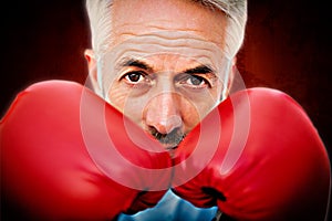 Composite image of close-up portrait of a determined senior boxer