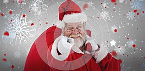 Composite image of close-up portrait of santa claus pointing while carrying christmas bag