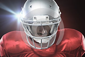 Composite image of close-up of serious american football player in red jersey looking down