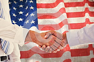 Composite image of close-up shot of a handshake in office