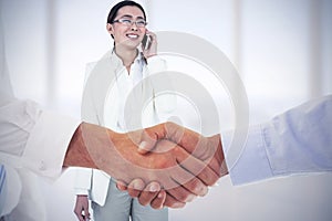 Composite image of close-up shot of a handshake