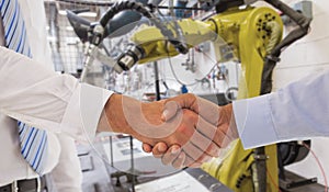 Composite image of close-up shot of a handshake in office