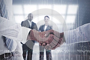 Composite image of close-up shot of a handshake in office