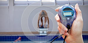 Composite image of close up of woman is holding a stopwatch on a white background