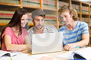 Composite image of college students using laptop in library