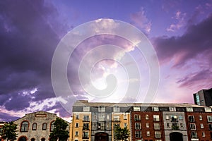 Composite image of colored houses against purple sky