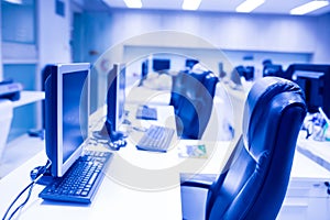 Composite image of computer in office or training room