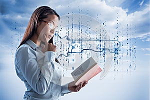 Composite image of concentrated businesswoman reading book