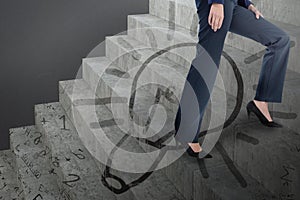 Composite image of conceptual image of businesswoman in heels climbing steps