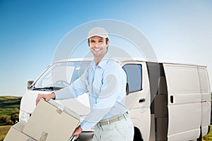 Composite image of confident delivery man pushing trolley of cardboard boxes