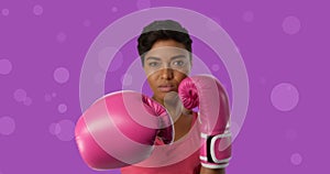 Composite image of confident female boxer against purple background, copy space