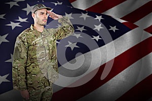 Composite image of confident military soldier saluting