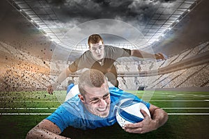 Composite image of confident rugby player lying in front with ball