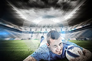 Composite image of confident rugby player lying in front with ball