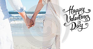 Composite image of couple on the beach looking out to sea holding hands