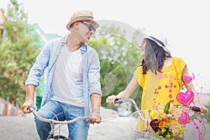 Composite image of couple on bike and valentines hearts 3d