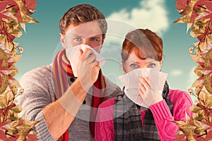Composite image of couple blowing noses into tissues