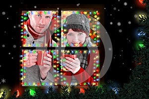 Composite image of couple both having warm drinks