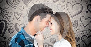Composite image of couple embracing against grey background with valentines hearts