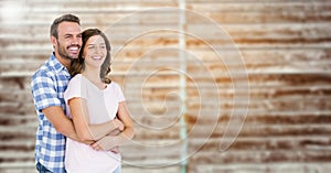 Composite image of couple embracing each other against brick background