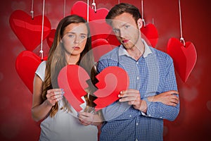 Composite image of couple holding broken heart 3d