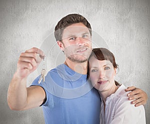 Composite image of couple holding keys to home