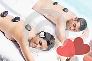 Composite image of a couple receiving a massage