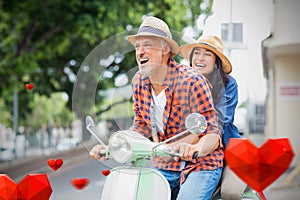 Composite image of couple on scooter and valentines hearts 3d