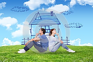 Composite image of couple sitting on floor together