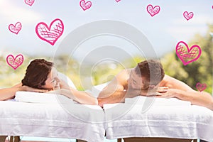 Composite image of couple in spa and valentines hearts 3d
