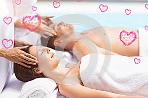 Composite image of couple in spa and valentines hearts 3d