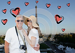 Composite image of couple standing against digitally generated eiffel tower and hearts