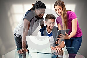 Composite image of creative team looking at digital tablet